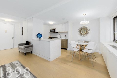 a kitchen and dining room with a table and chairs